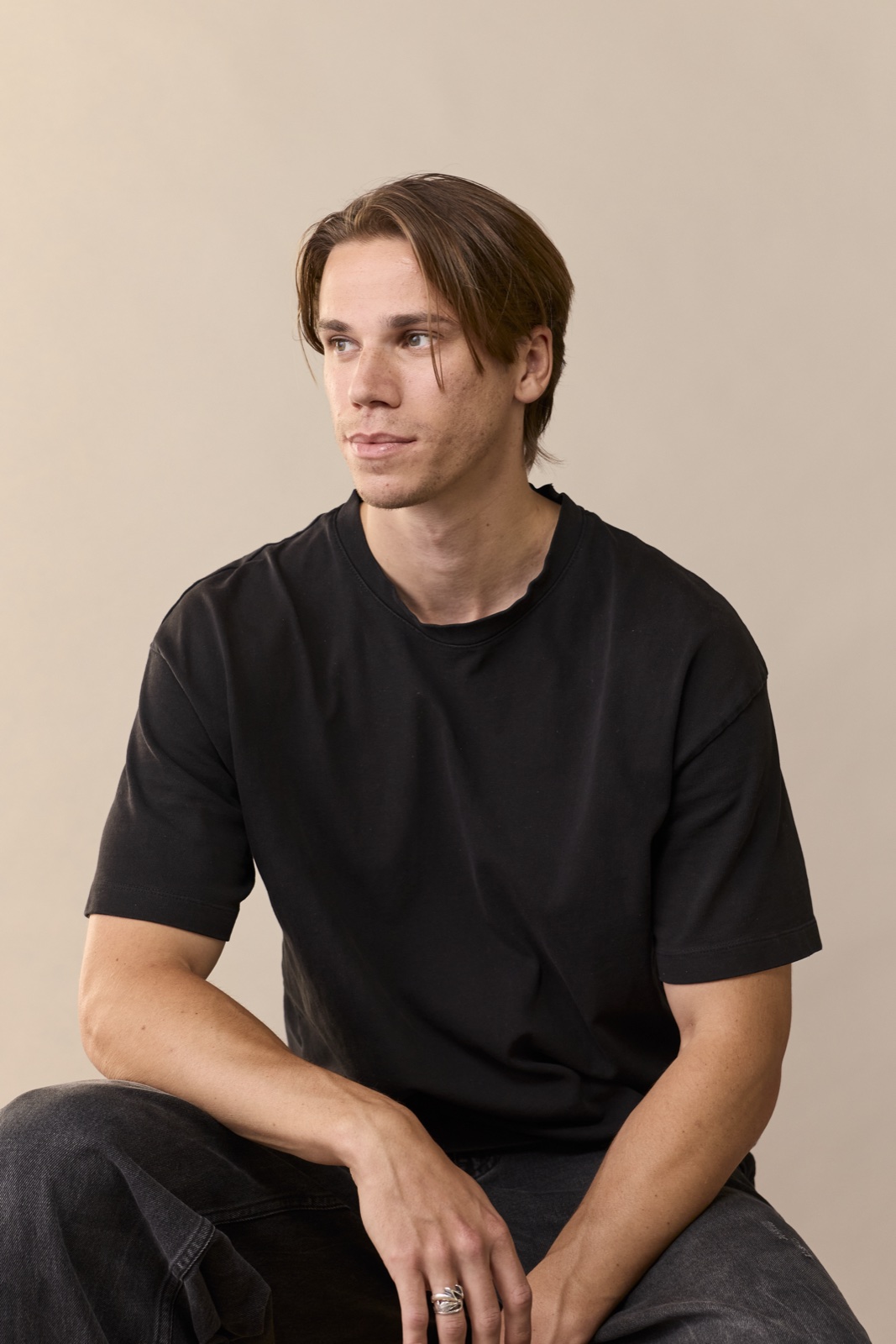 Rafe Johnson in a black t-shirt against a warm studio backdrop