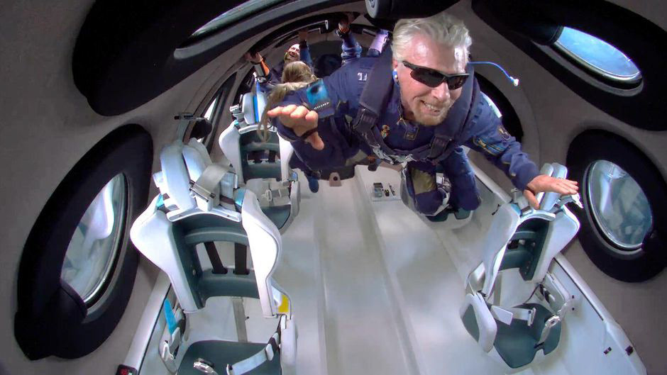 A passenger floating in zero gravity inside the Virgin Galactic cabin during spaceflight